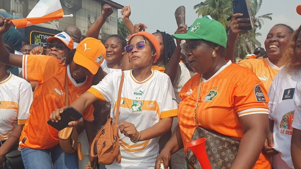 Fans dance in the street as they celebrate the Elephants' third Afcon win